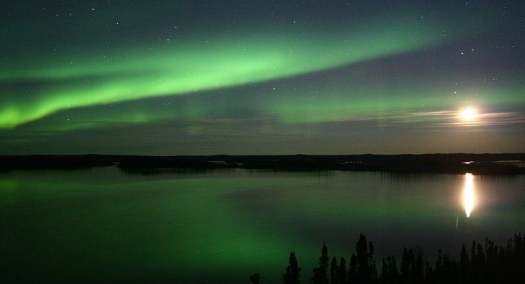 月明かりに照らされた湖面に緑のオーロラが映る静かな夜景で、レイキと宇宙エネルギーのやさしい広がりをイメージした写真